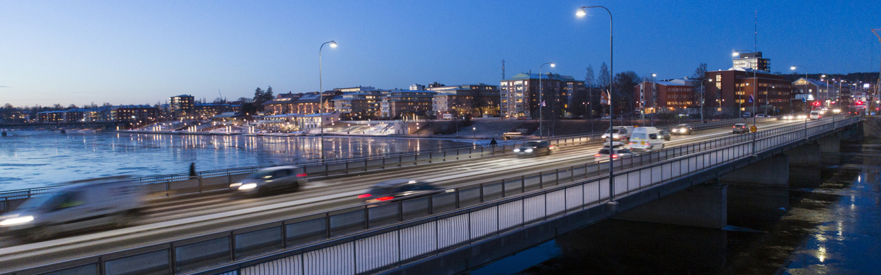 En bro över ett vattendrag med bilar som kör på den.